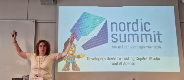 Claire Edgson from Capgemini with both arms raised in front of her title slide A Developer's Guide to Testing Copilot Studio and AI Agents at Nordic Summit 2026