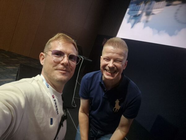 Kalle Spiik and Vesa Juvonen in front of the Runway 2 stage at HELish Summit 2026