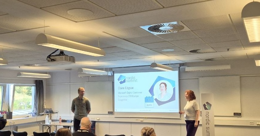 Tatu Seppälä and Claire Edgson at the front of the Editions room at Nordic Summit 2026 with the intro slide of their MCP vs A2A session