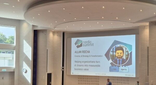 Allan Rocha, Director of AI Strategy and Transformation at Fellowmind, on stage in the Duplo hall at Nordic Summit 2026 with his intro slide