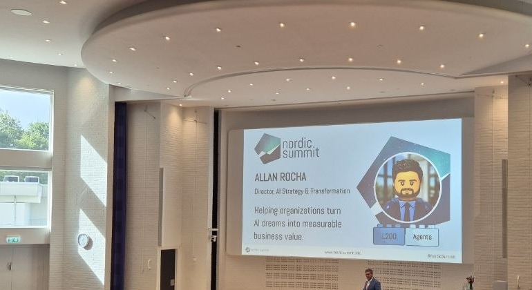 Allan Rocha, Director of AI Strategy and Transformation at Fellowmind, on stage in the Duplo hall at Nordic Summit 2026 with his intro slide