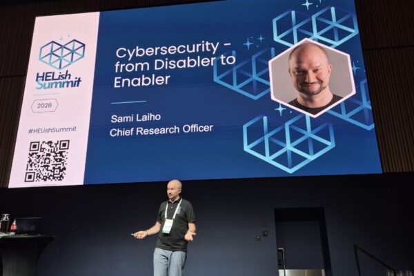 Sami Laiho on stage at HELish Summit 2026 in front of his title slide: Cybersecurity, from Disabler to Enabler, Chief Research Officer