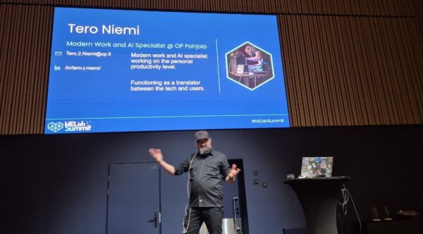 Tero Niemi, Modern Work and AI Specialist at OP Pohjola, on stage at HELish Summit 2026 with his intro slide