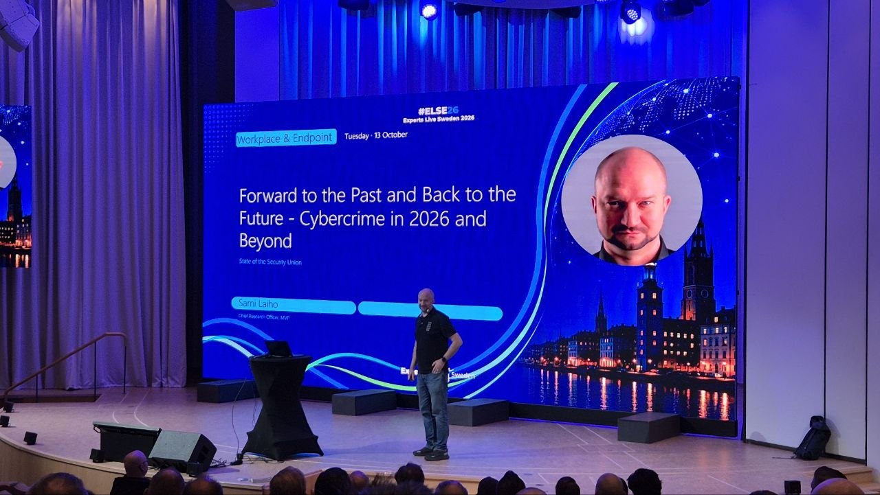 Sami Laiho on stage in the auditorium in front of his title slide, Forward to the Past and Back to the Future: Cybercrime in 2026 and Beyond